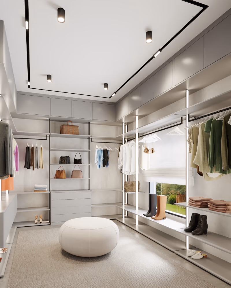Walk-in closet with open metal shelving, lit hanging rails, and a round ottoman.