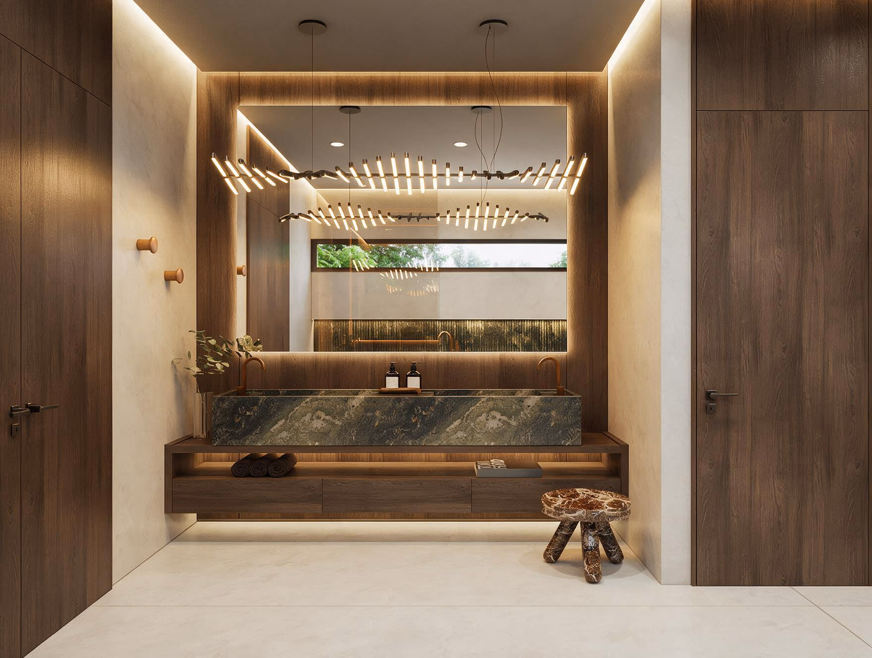 Primary bathroom with a floating walnut vanity, a green marble basin, a backlit mirror, linear pendant lights, and a carved wood stool.