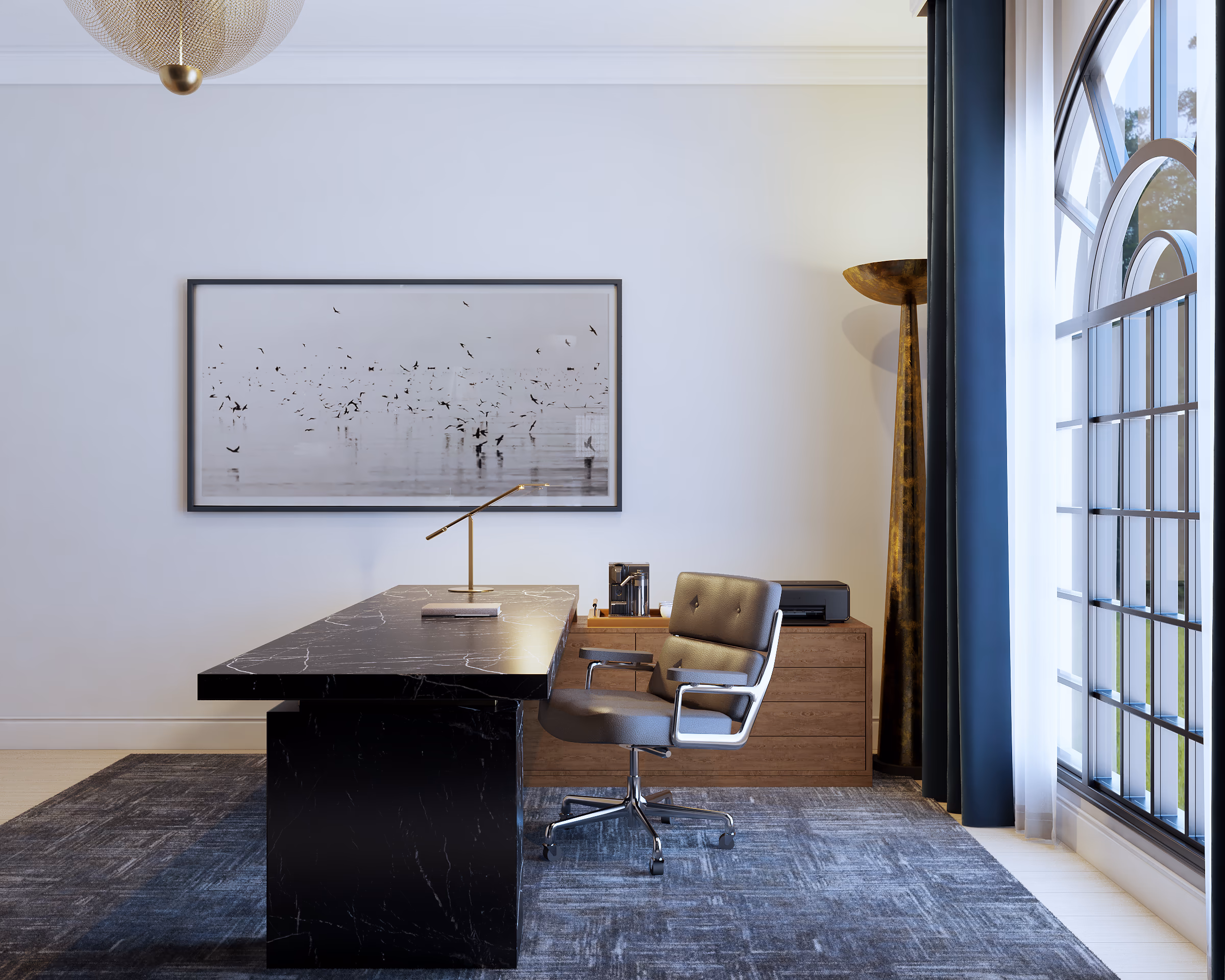 Home office with a black executive desk, a leather chair, and artwork on a white wall.