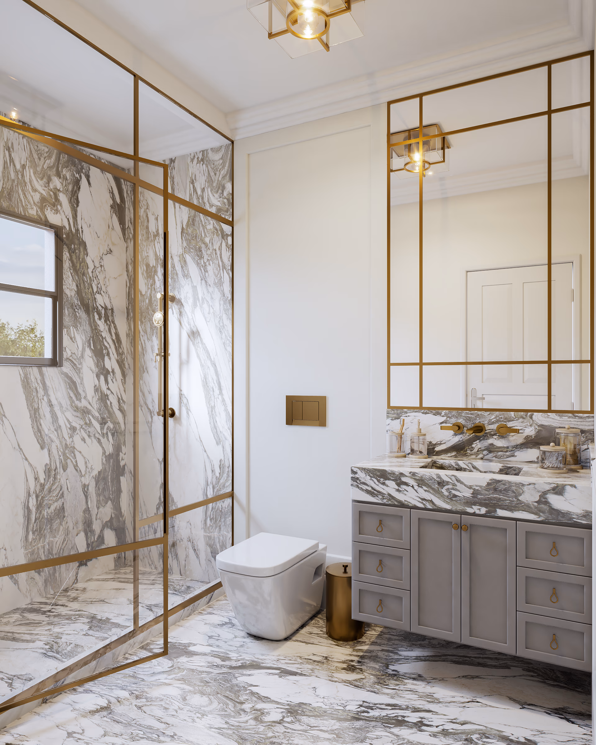 Bathroom with a veined marble shower behind brass-framed glass and a gray vanity with a marble top.